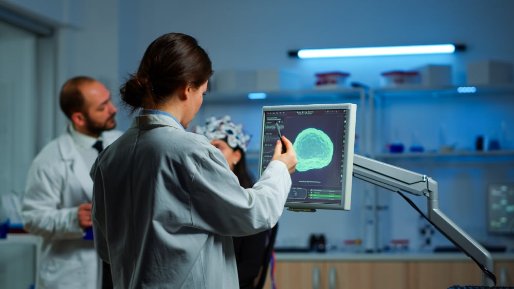 Female patient undergoing neurological testing as doctor monitors brain activity to understand what is ALS in a clinical setting