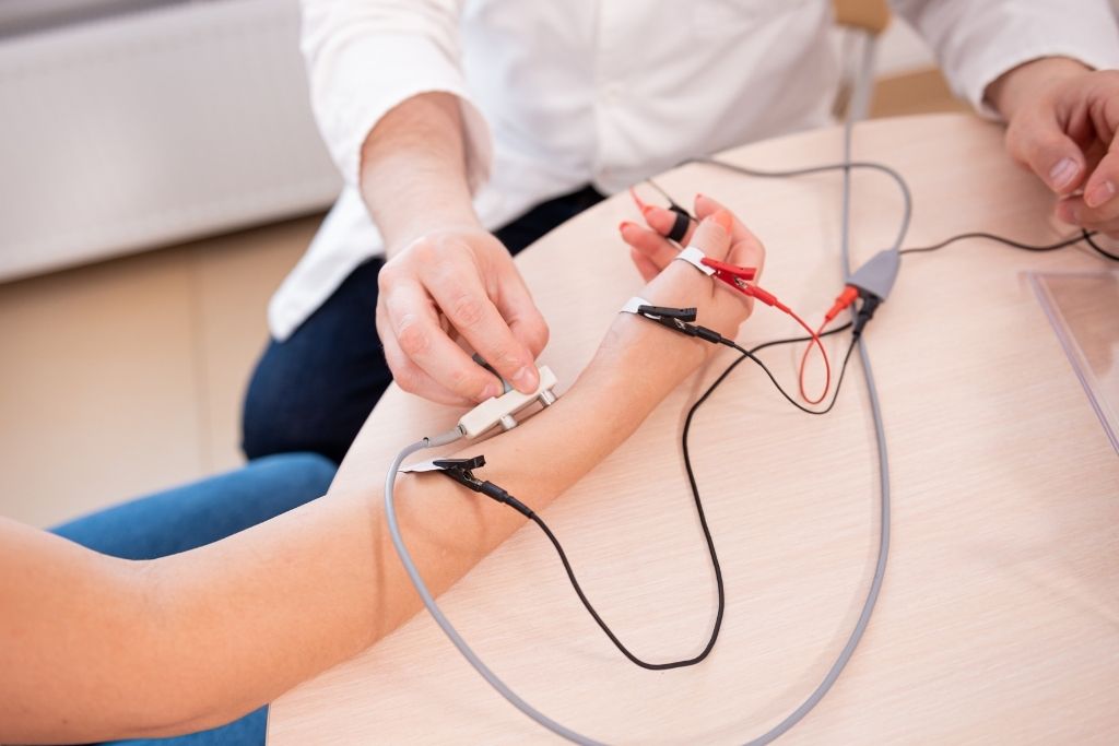 What does a nerve conduction test diagnose? Technician performing an NCS