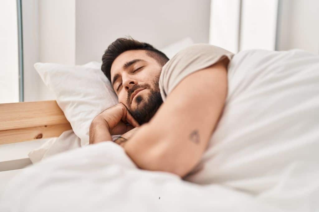 Man sleeping on his side in bed, illustrating how to test for sleep apnea at home